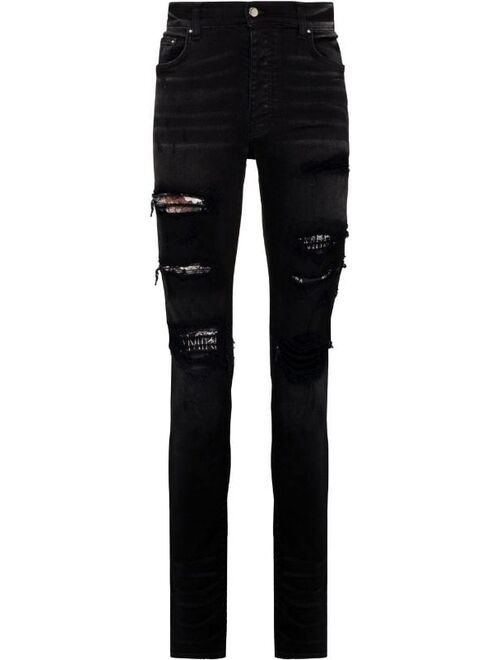AMIRI Hibiscus art patch skinny jeans