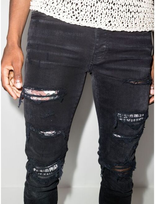 AMIRI Hibiscus art patch skinny jeans