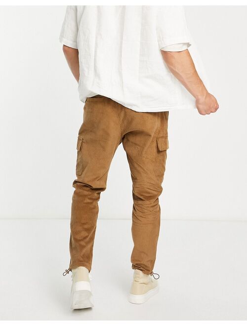 ASOS DESIGN tapered fit cargo pants in cord in brown