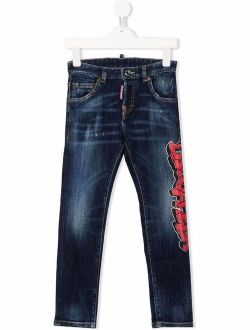 Kids graffiti-logo slim-cut jeans