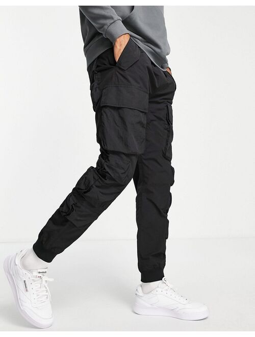 Buy Topman relaxed nylon multi pocket cargo pants in black online ...