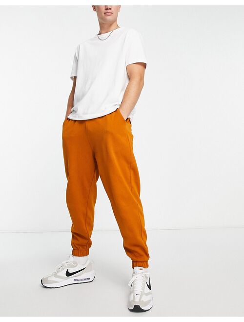 ASOS DESIGN oversized sweatpants in washed orange