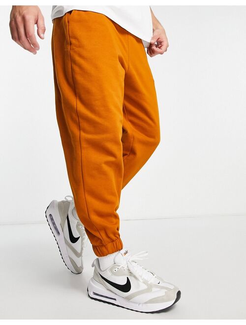 ASOS DESIGN oversized sweatpants in washed orange