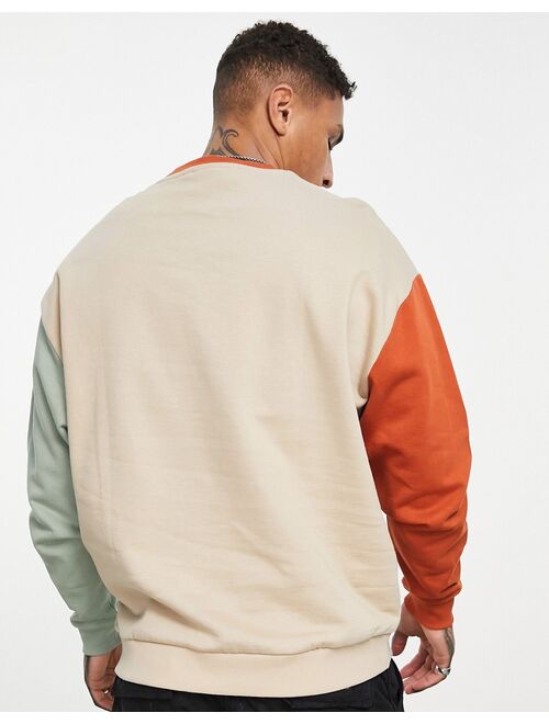 ASOS DESIGN oversized sweatshirt in brown color block with splice print