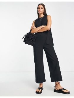 twill minimal sleeveless jumpsuit with pockets in black