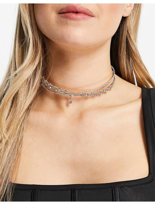 ASOS DESIGN choker necklace with crystal cross over design and crystal pendant in gold tone