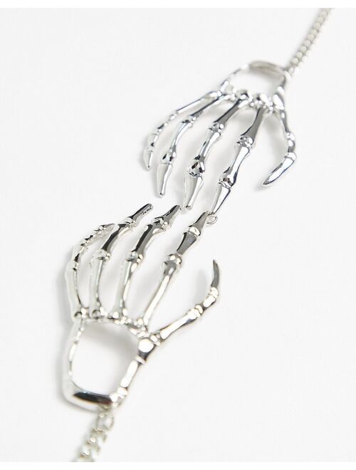 ASOS DESIGN Halloween choker necklace with skeleton hands in silver tone