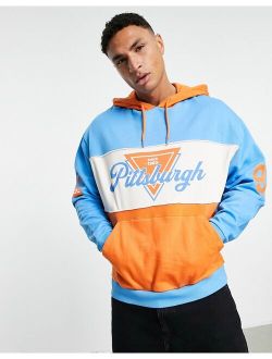 oversized hoodie in blue & orange color block with multiplacement print