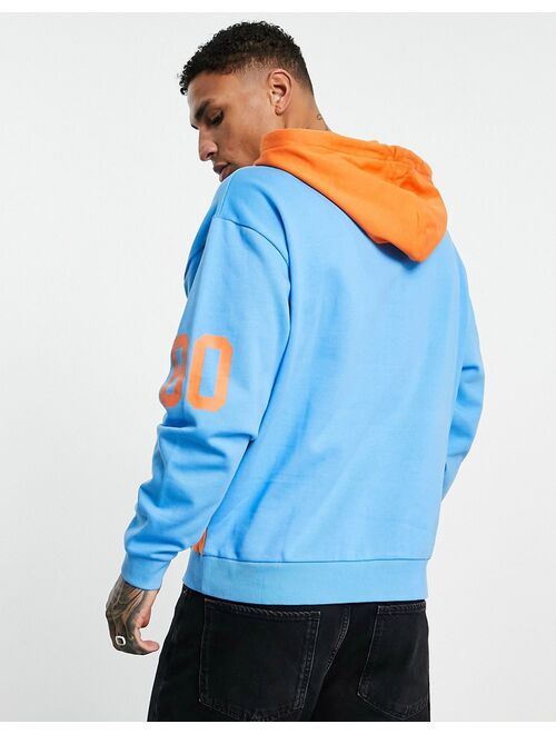 ASOS DESIGN oversized hoodie in blue & orange color block with multiplacement print