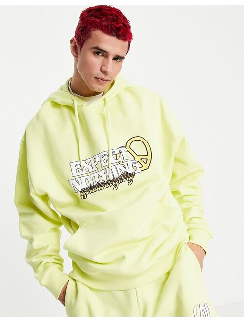 ASOS DESIGN oversized hoodie in yellow with text print - part of a set