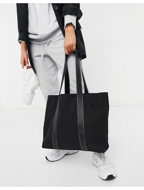 Buy ASOS DESIGN canvas tote bag with leather-look straps in black ...