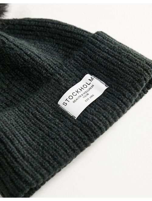 ASOS DESIGN rib knit pom beanie with label detail in black