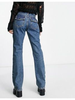 low rise flared jeans with western pocket detail in tinted blue