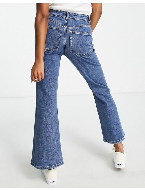 ASOS DESIGN Petite flared jeans in mid blue