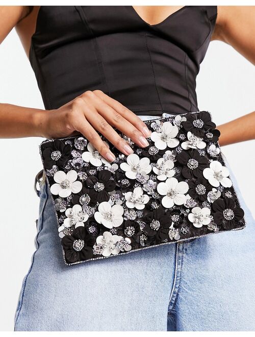 ASOS DESIGN clutch with 3D flowers in black