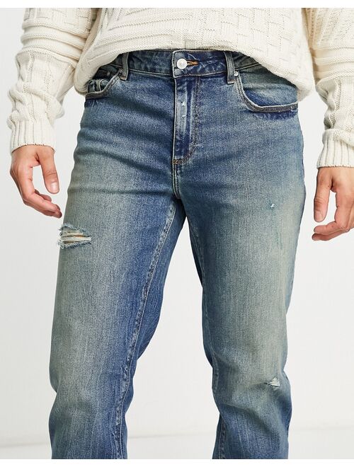 ASOS DESIGN stretch tapered jeans in tinted wash with abrasions