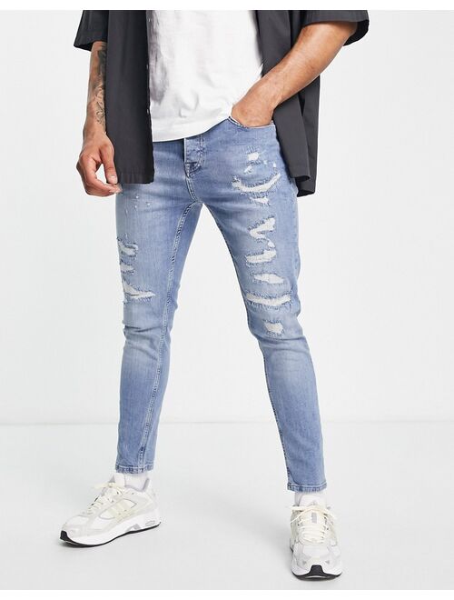 Topman stretch taper rip and repair jeans in mid wash blue