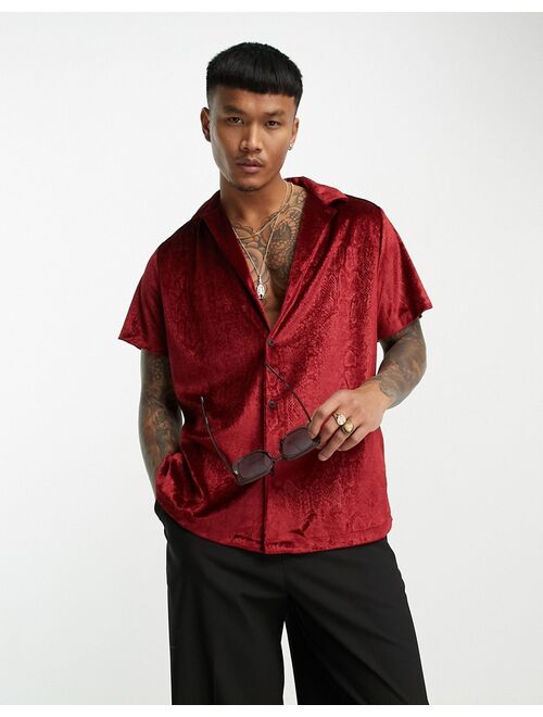 ASOS DESIGN relaxed velvet shirt with embossed snake print in red