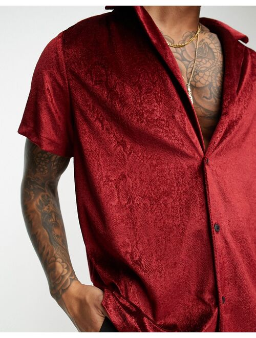 ASOS DESIGN relaxed velvet shirt with embossed snake print in red