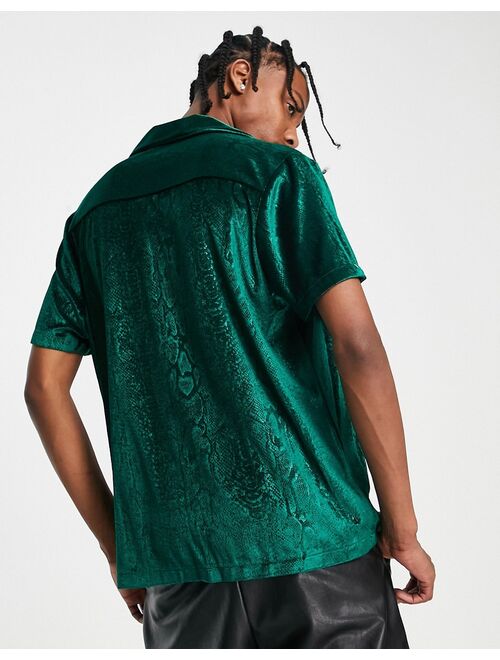 ASOS DESIGN relaxed velvet shirt with embossed snake print in green