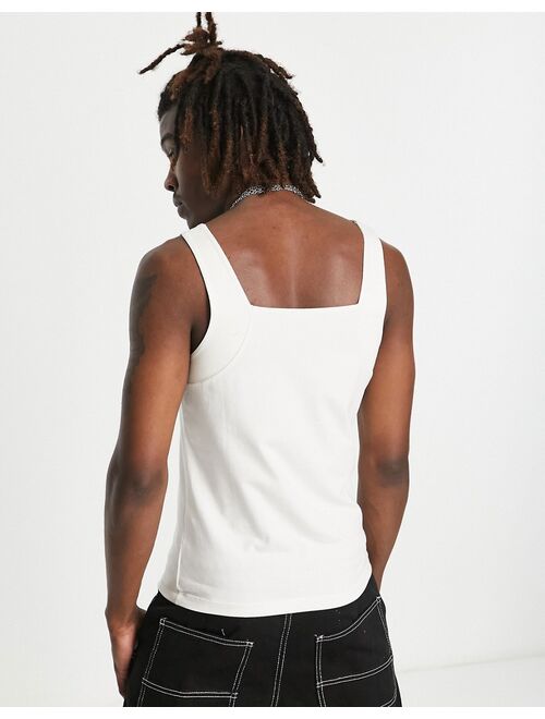 ASOS DESIGN muscle tank top in cream with 'Forget' chest embroidery