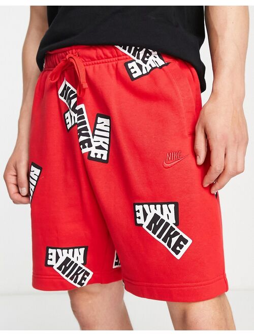 Nike Sport Essentials all over sticker print fleece shorts in red