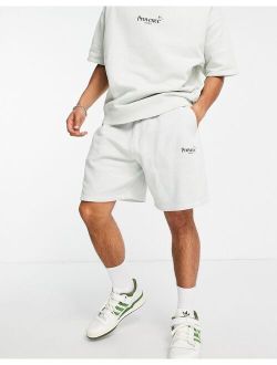 oversized shorts in washed white cotton with city print - WHITE