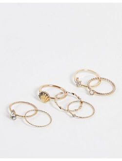 pack of 7 rings with shell design in gold tone