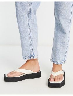 faux leather thong sandals in black and white