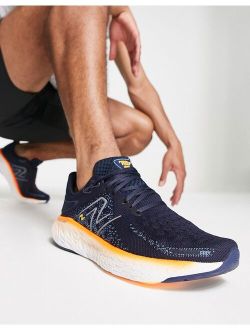 Running 1080 sneakers in navy and orange