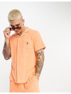 x ASOS exclusive collab terrycloth camp collar shirt in orange with back print logo