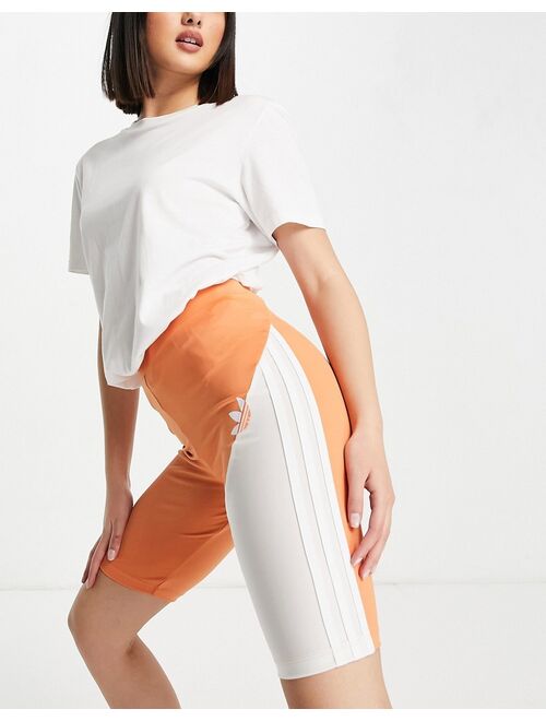 adidas Originals sliced trefoil legging shorts in white and hazy copper