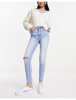 super high waist skinny jean with rip in light blue