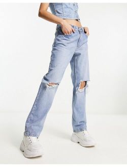 loose straight jeans with knee rips in light blue