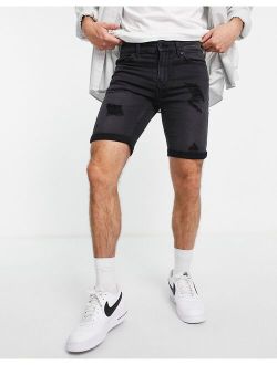 denim shorts in slim fit with distressing in black