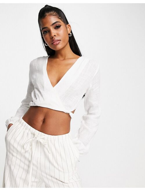 Pull&Bear rustic long sleeve cut out wrap front cropped top in off white