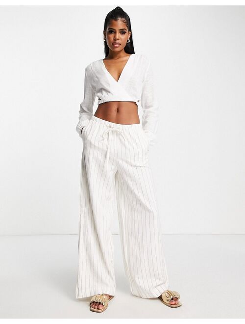 Pull&Bear rustic long sleeve cut out wrap front cropped top in off white