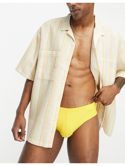 ASOS DESIGN swim briefs in yellow
