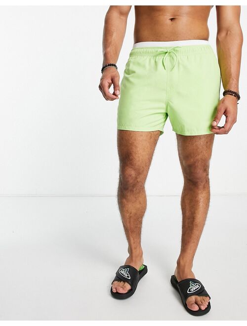 ASOS DESIGN swim shorts in short length with double waistband in lime green