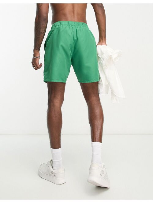 ASOS DESIGN swim shorts in short length with 'Arizona' print in green