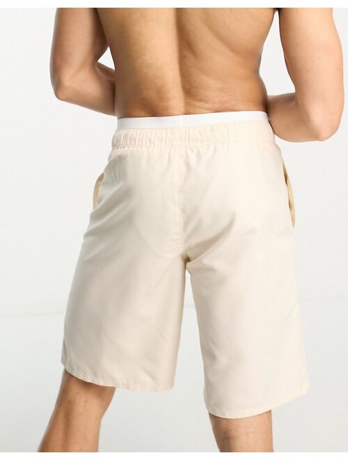 ASOS DESIGN swim shorts in long length with double waistband in beige