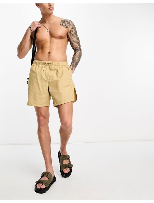ASOS DESIGN swim shorts in short length in beige