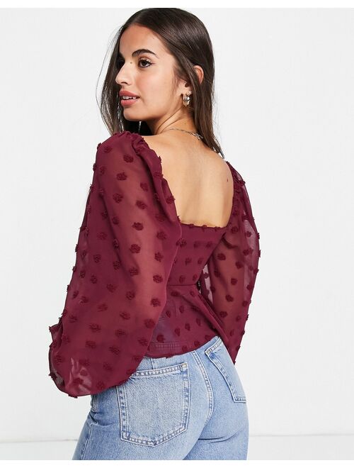 ASOS DESIGN textured sheer volume sleeve blouse with tie front detail in oxblood