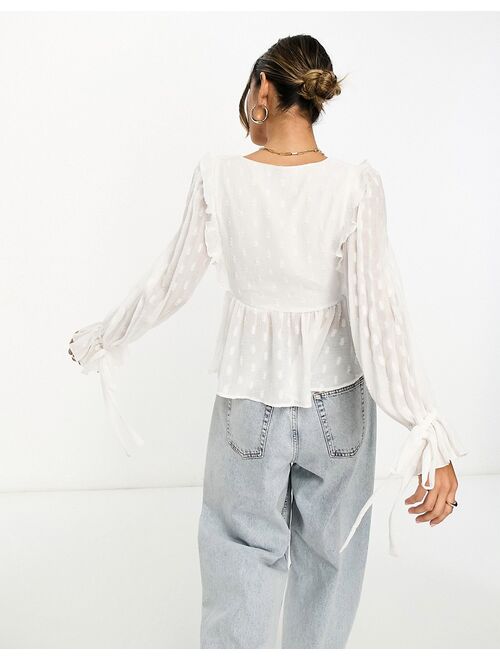 ASOS DESIGN long sleeve textured top with wrap & ruffle cuff in ivory