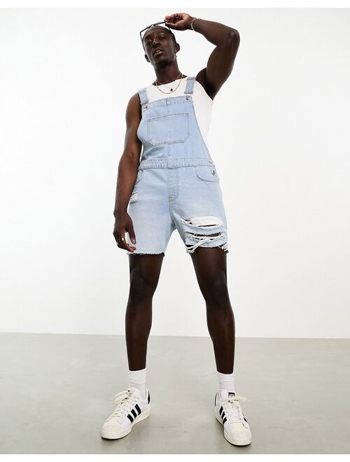 ASOS DESIGN overalls in light wash blue with heavy rips in shorter length