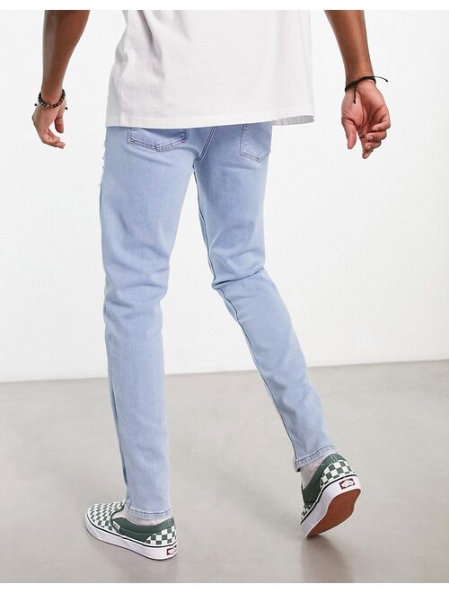 ASOS DESIGN skinny jeans with heavy rips in light wash blue