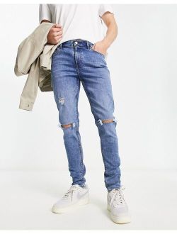 skinny jeans in mid wash blue with rips