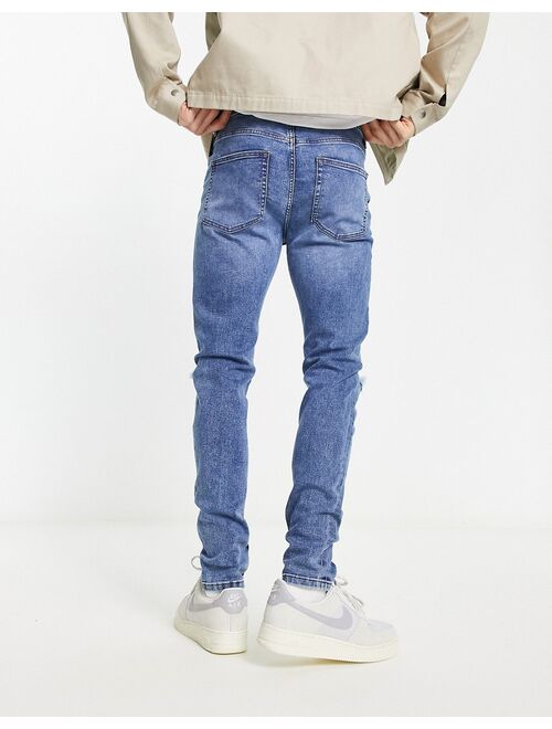 ASOS DESIGN skinny jeans in mid wash blue with rips