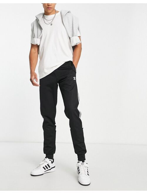 adidas Originals Tall adicolor Challenger three stripe slim fit sweatpants in black