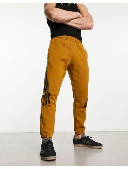 performance adidas Sportswear Future Icons 3 stripes sweatpants in dark orange